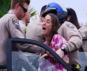 The unforgettable image of Erica being arrested when they ripped her babies from her. Photo courtesy of ksbw.com.