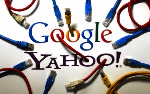 An illustration picture shows the logos of Google and Yahoo connected with LAN cables in a Berlin office, October 31, 2013. REUTERS/Pawel Kopczynski​